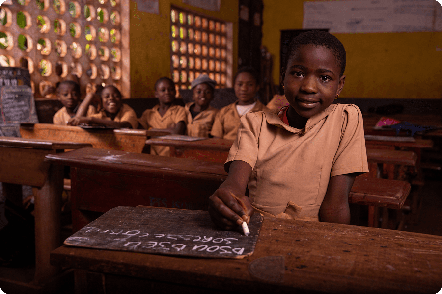 Smiling student sitting at wooden desk